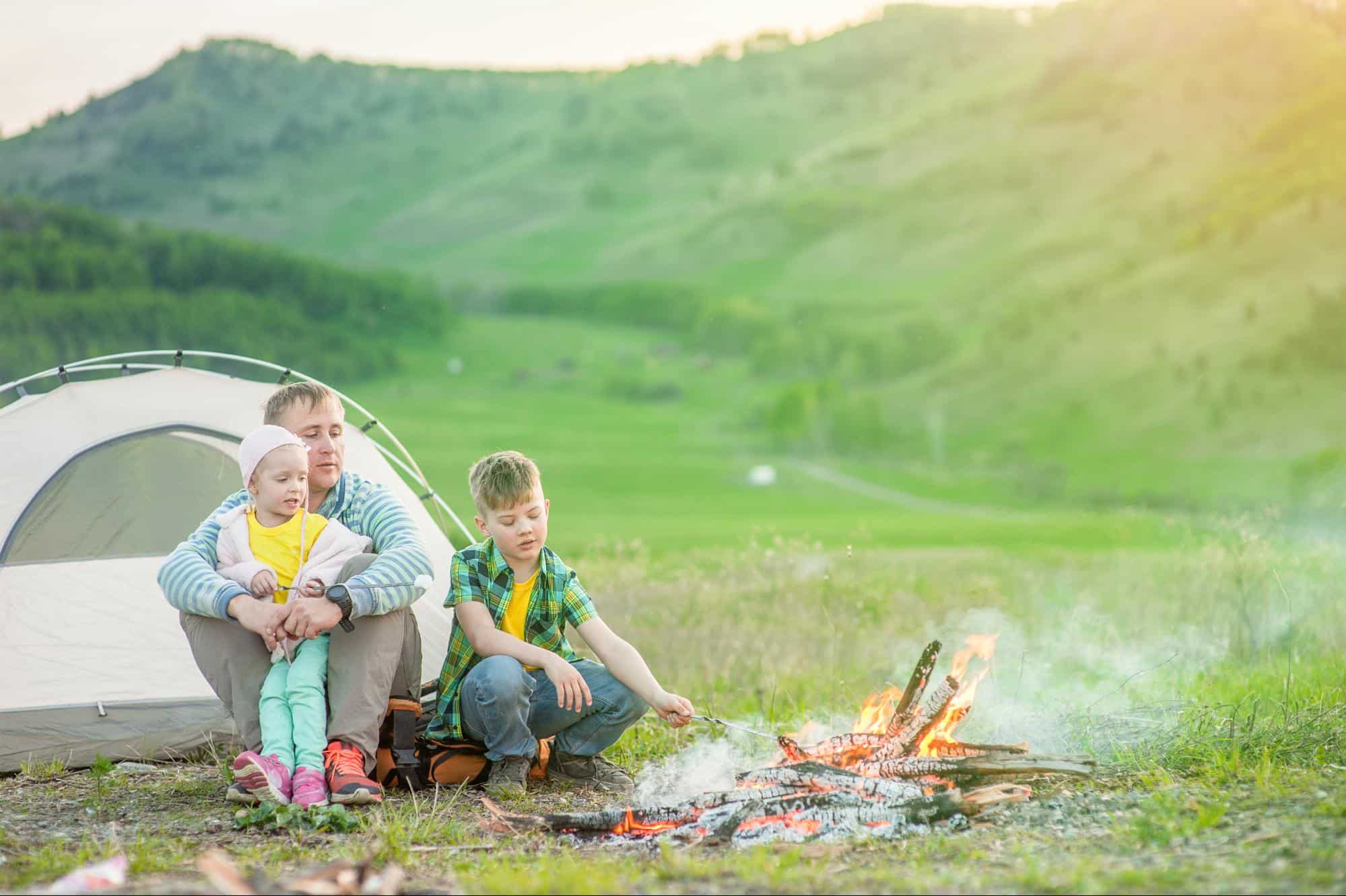 A family camping with a campfire